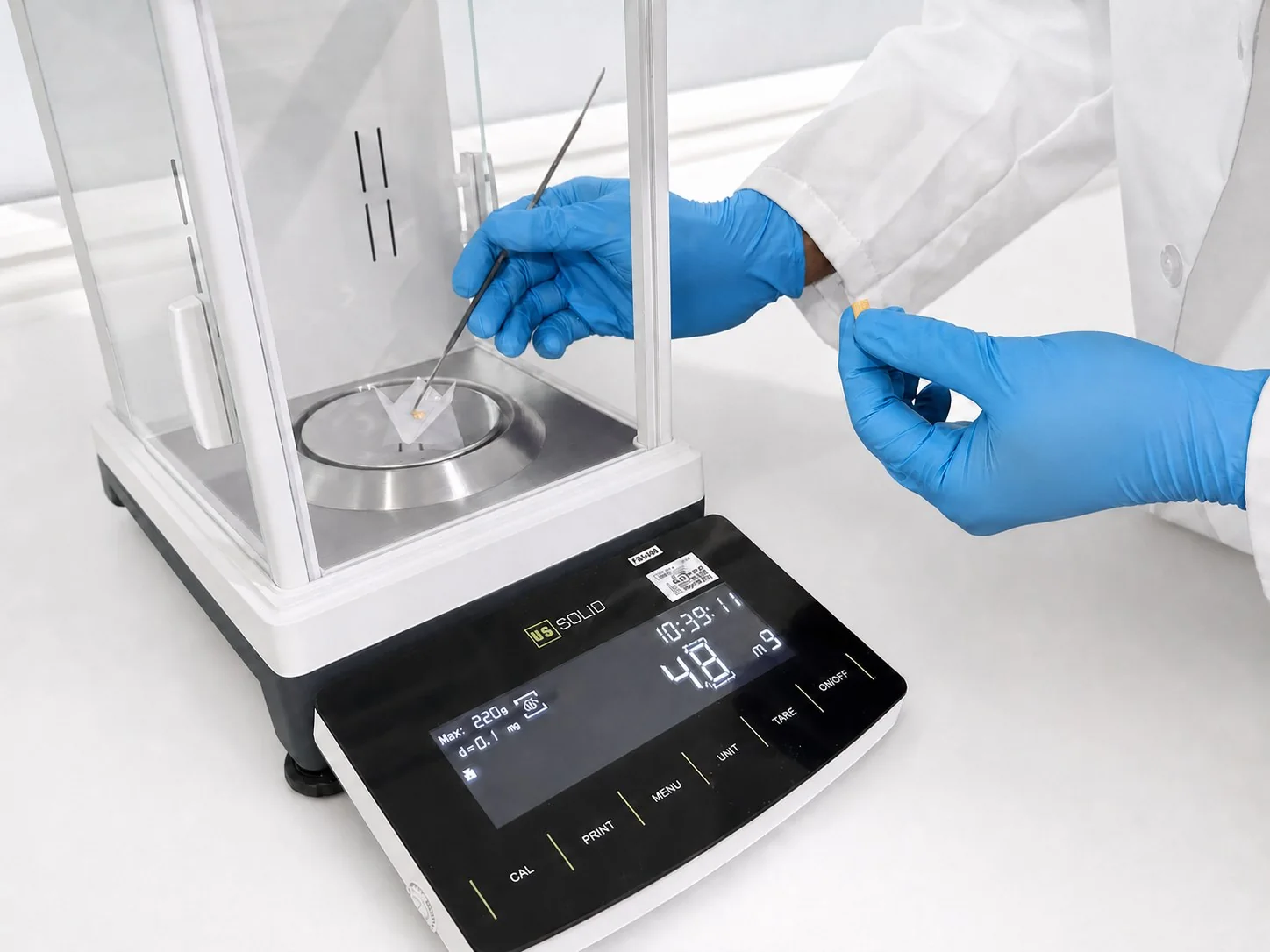 Analytical balance in use with sample
